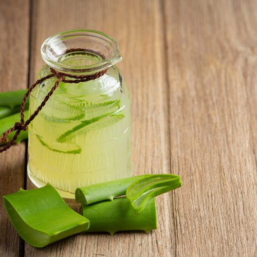 a glass of aloe vera  juice put on wooden  floor